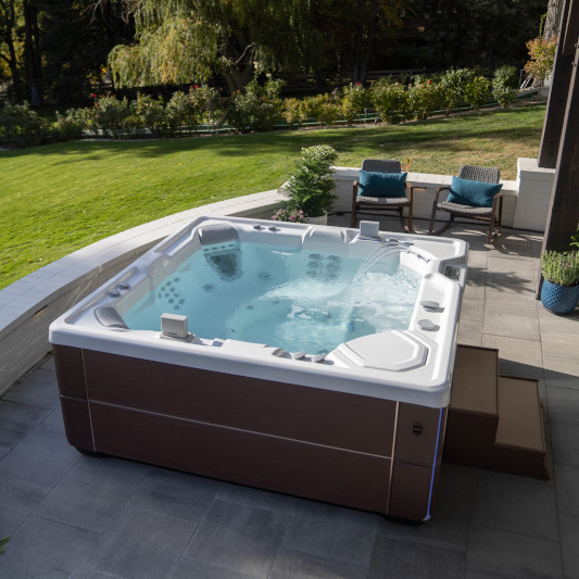 Highlife Collection Vanguard spa in Alpine White with Java cabinet on a patio